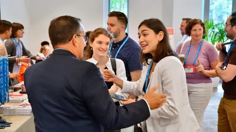 registrants arriving and talking at the beginning of the 2024 conference