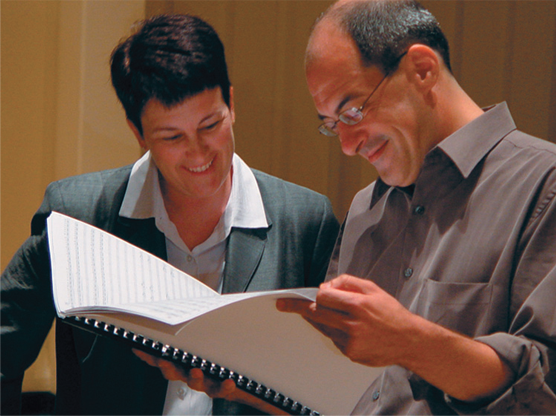 two choir professionals reviewing a choral score