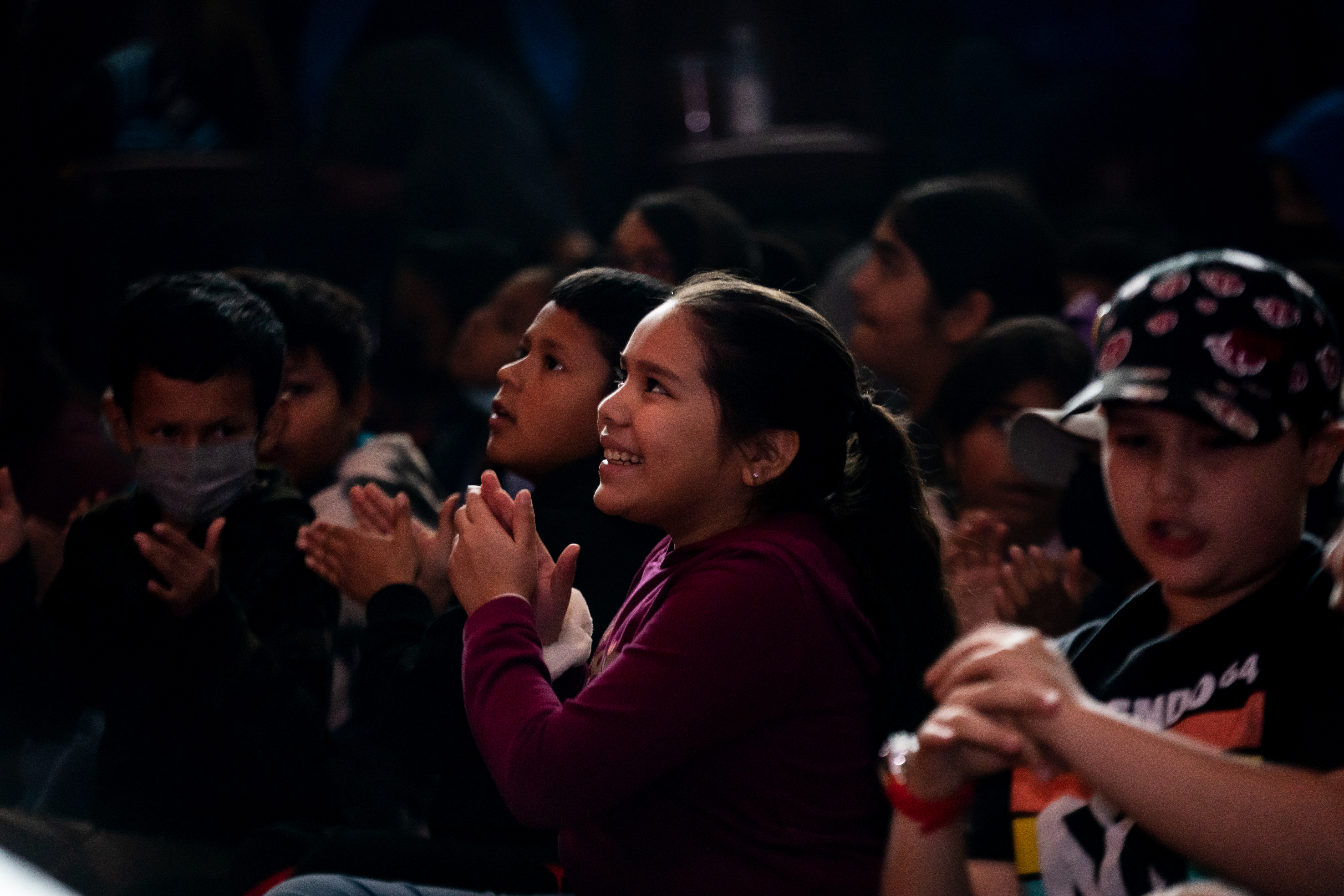 Child watching a musical performance and clapping