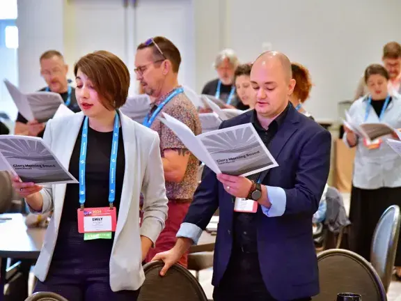 chorus singers singing in group exercise at conference