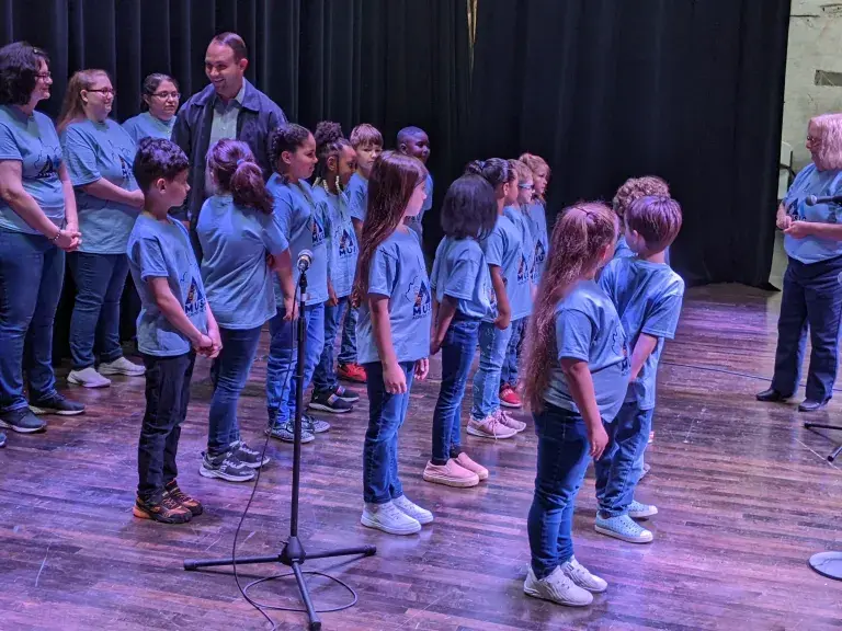 Adults and children sing together in Bluefield, WV