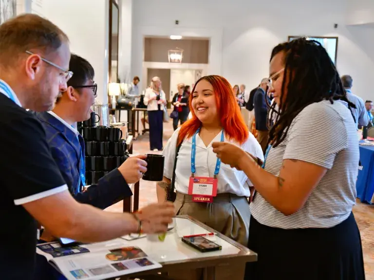 exhibitors talking to attendees of conference