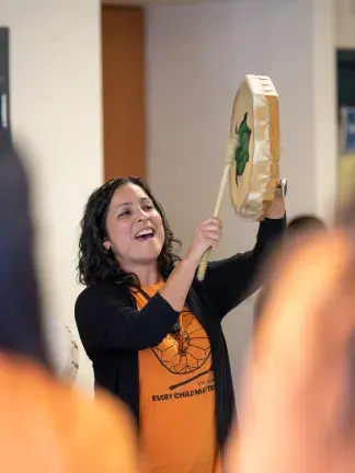 Deanna Gestrin leads drumming and singing with participants of the VYC KINDRED program