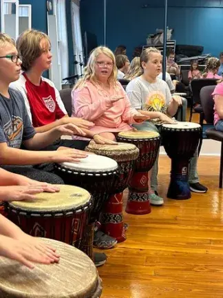 Students drumming and singing