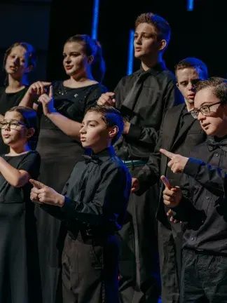 Students singing and signing at a performance.