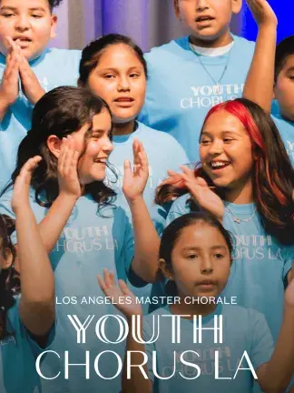 Students smiling while singing and clapping their hands.