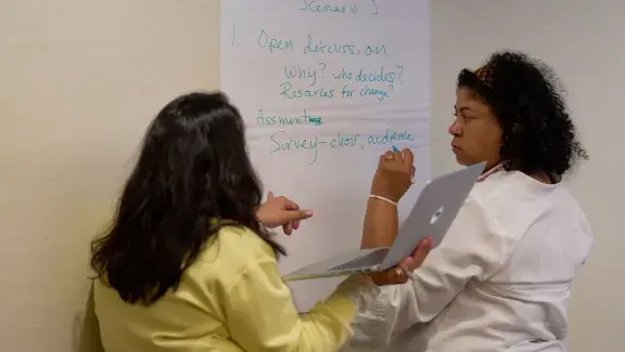 Person writing scenario on paper for in-depth session
