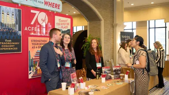 ACFEA booth and people talking