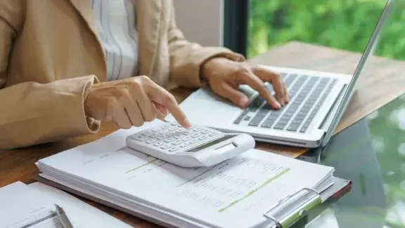 stock image of person using a calculator